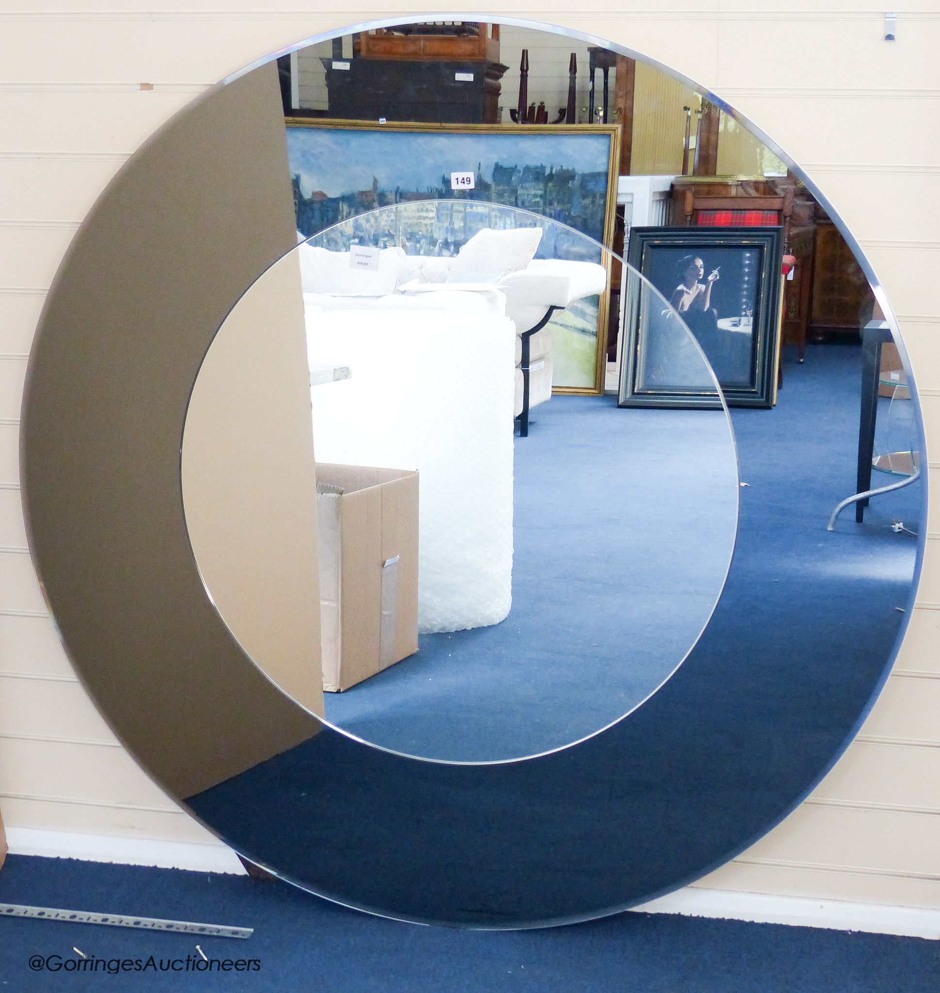 A large Porada Forvanity smoked and clear glass circular mirror, 130 cm diameter